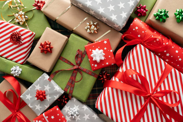 Christmas gift boxes, wrapped gifts, festive presents composition. Winter holiday season gift guide concept. Xmas flat lay on wooden background.